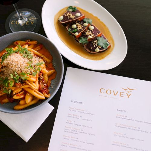 Sauteed vegetables with tofu, a small bowl of beans, a cup of tea, and a handwritten note on a white notepad.